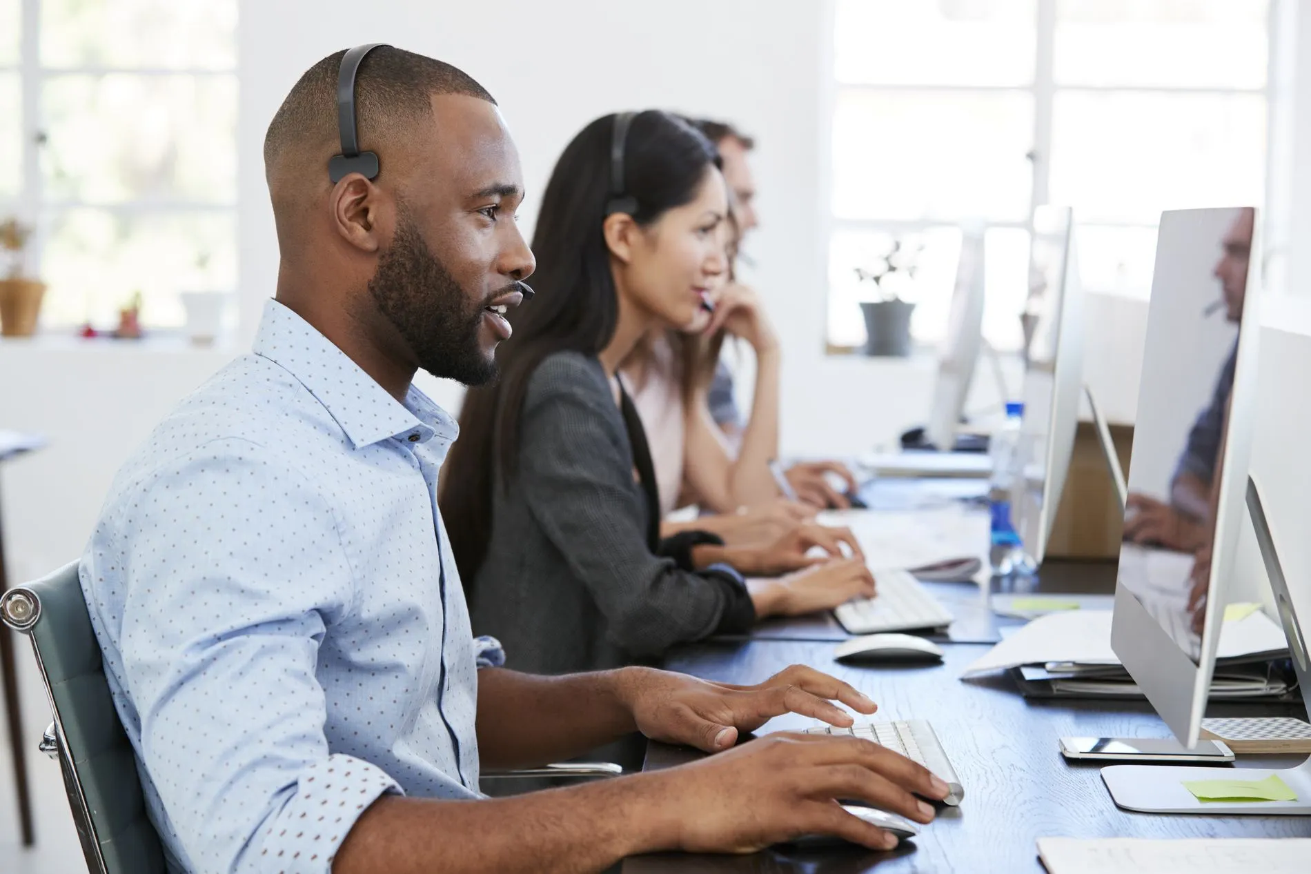 Computer technician providing support at a workstation